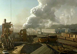 industrial scene with railway and lots of smoke